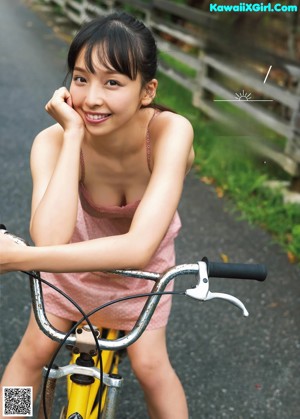 A woman in a red and black bikini posing for a picture.