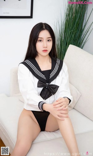 A woman in a school uniform sitting on a white couch.