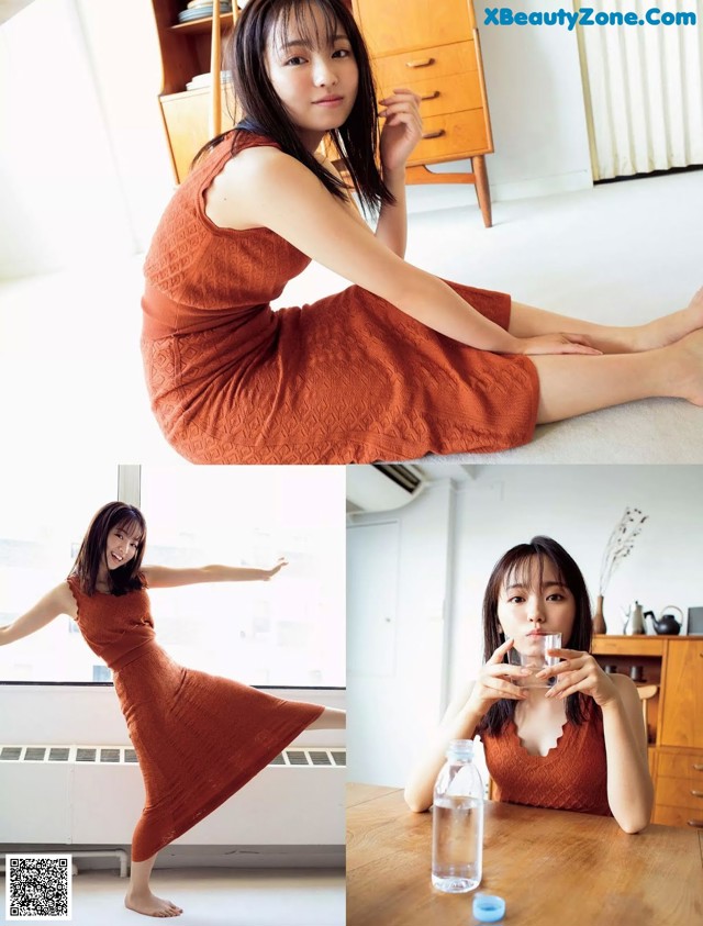 A woman in a brown dress sitting on a wooden table.