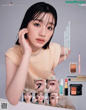 A woman in a green shirt is putting on makeup.