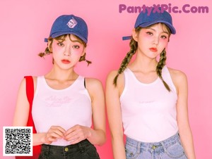 A couple of young women standing next to each other.