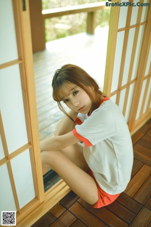 A young woman in a school uniform posing for a picture.