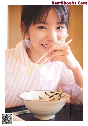 A young girl holding an ice cream cone in her hand.
