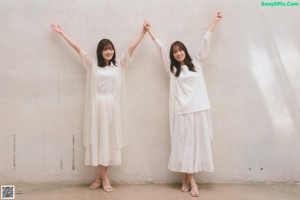 A magazine with two young women sitting next to each other.