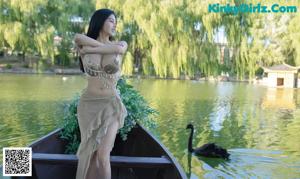 a woman in a bikini sitting on a boat