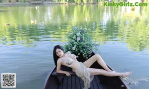 a woman in a bikini sitting on a bench