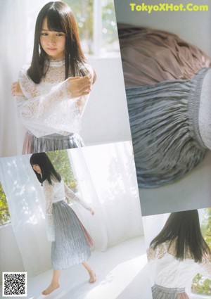 A young woman in a white lace top and a gray skirt.
