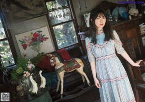 A woman sitting on a swing on a porch.