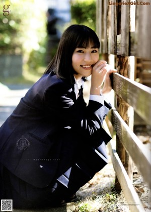 A woman with long brown hair is posing for a picture.