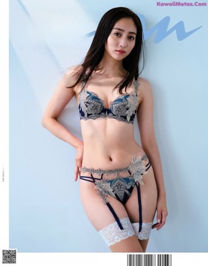 A woman wearing a black bra and black panties.