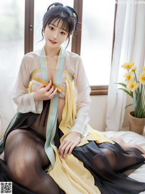 a woman in a blue and yellow hanbob sitting on a bed