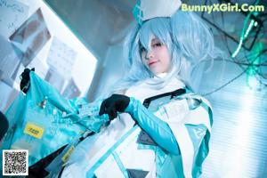 A woman in a bunny costume posing with a gun.