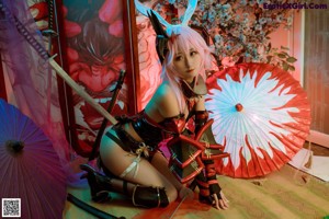 A woman with pink hair and bunny ears holding a sword.