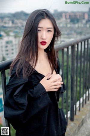 A woman in a white shirt and blue shorts posing for a picture.