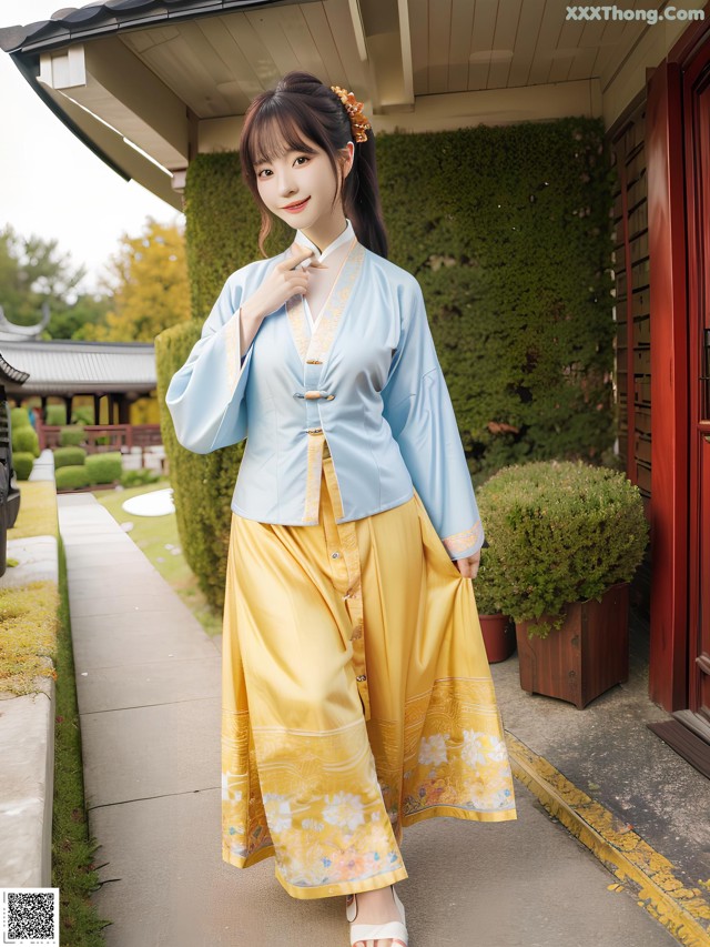 A woman in a blue and yellow hanbok is posing for a picture.